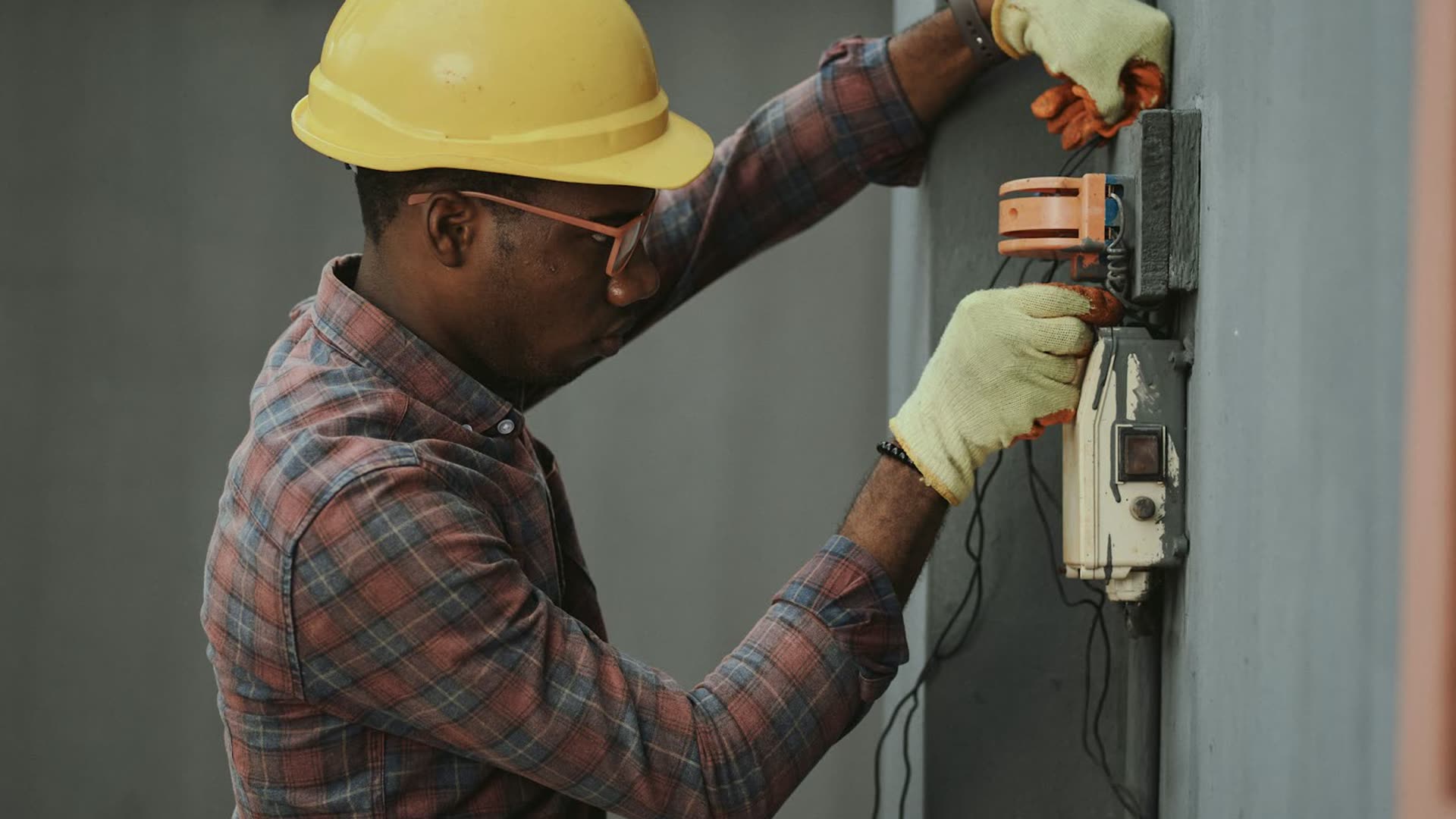Technician servicing an electrical control panel