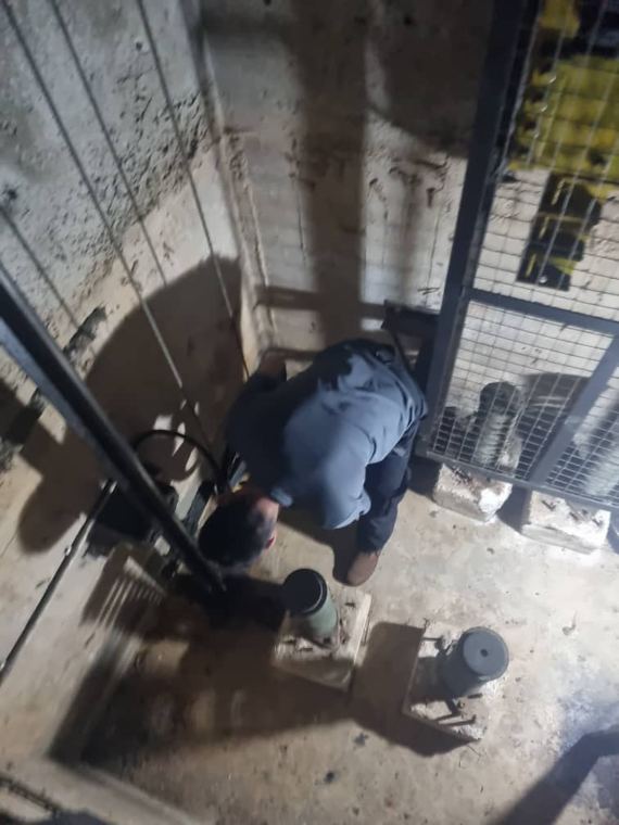Technician working in a lift pit